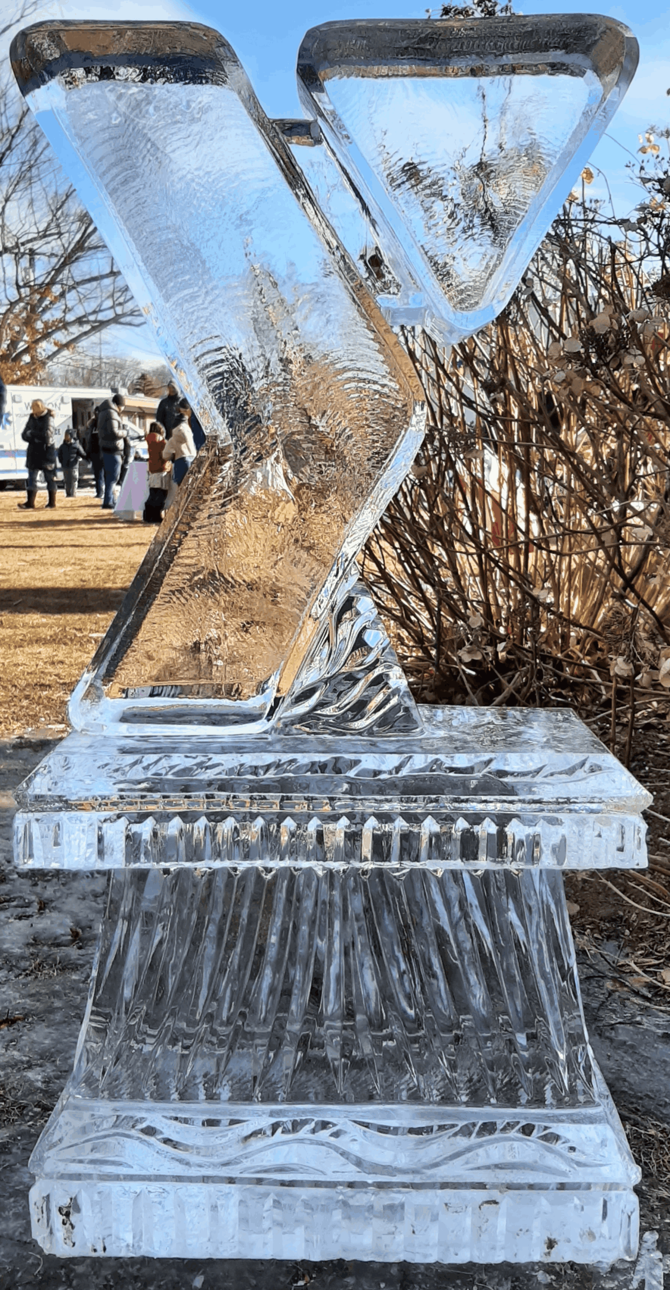 Sleek modern geometric wedge-shaped ice sculpture outdoors