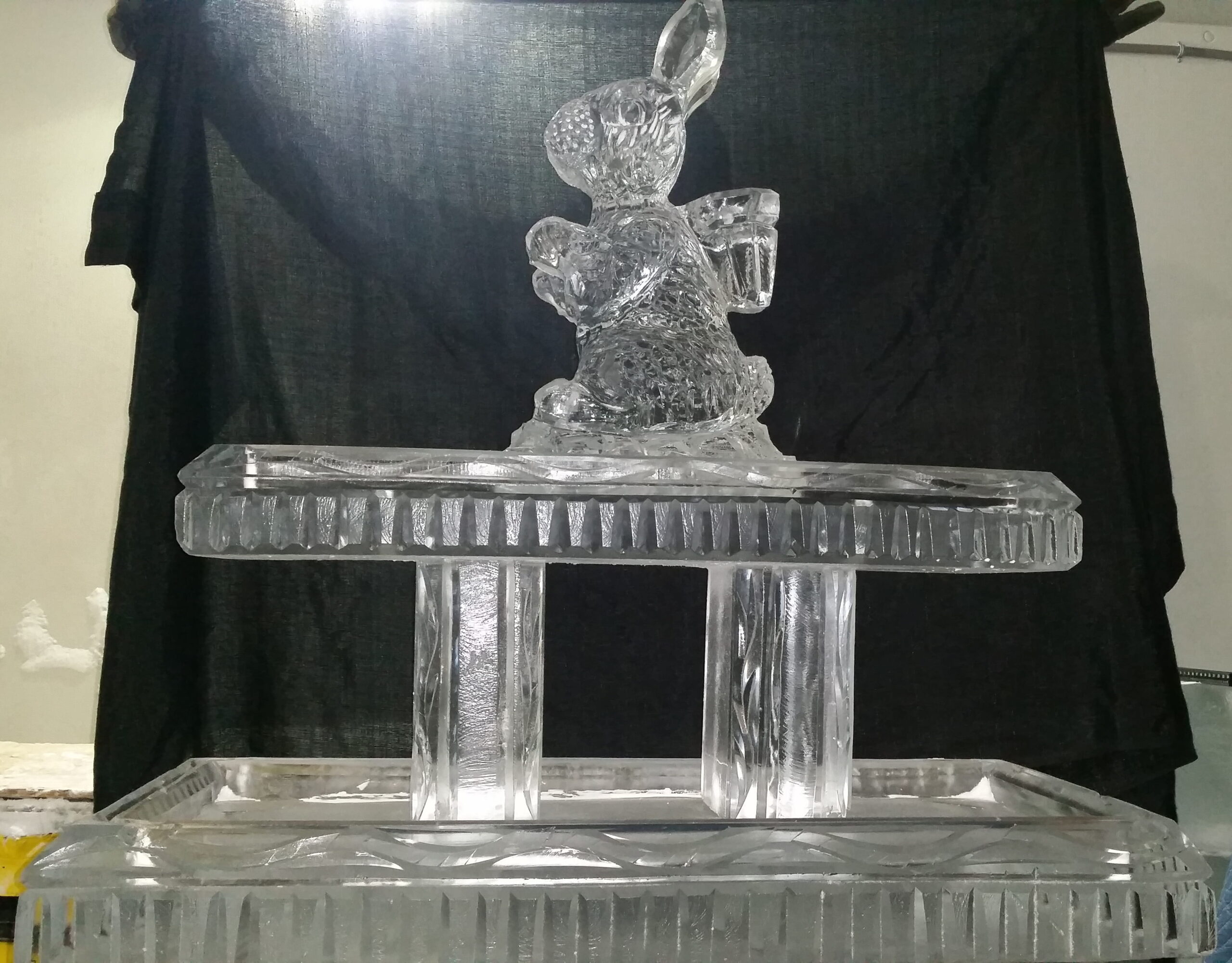Elegant ice sculpture on display pedestal