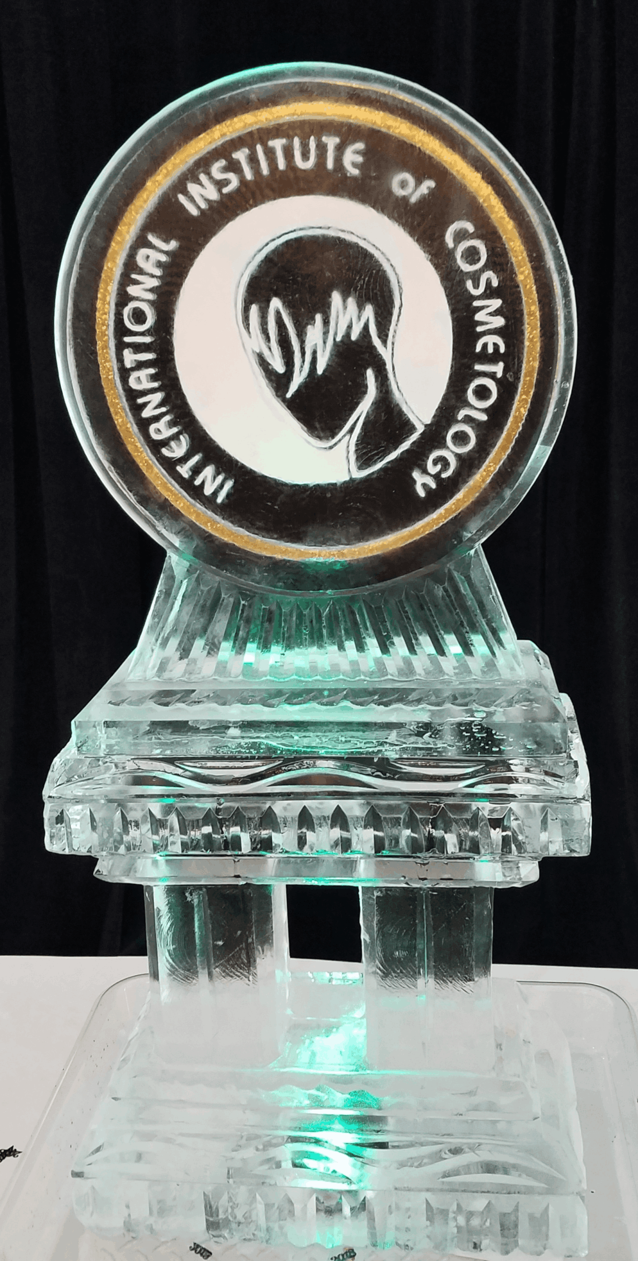 Custom circular corporate emblem ice sculpture with a ridged base