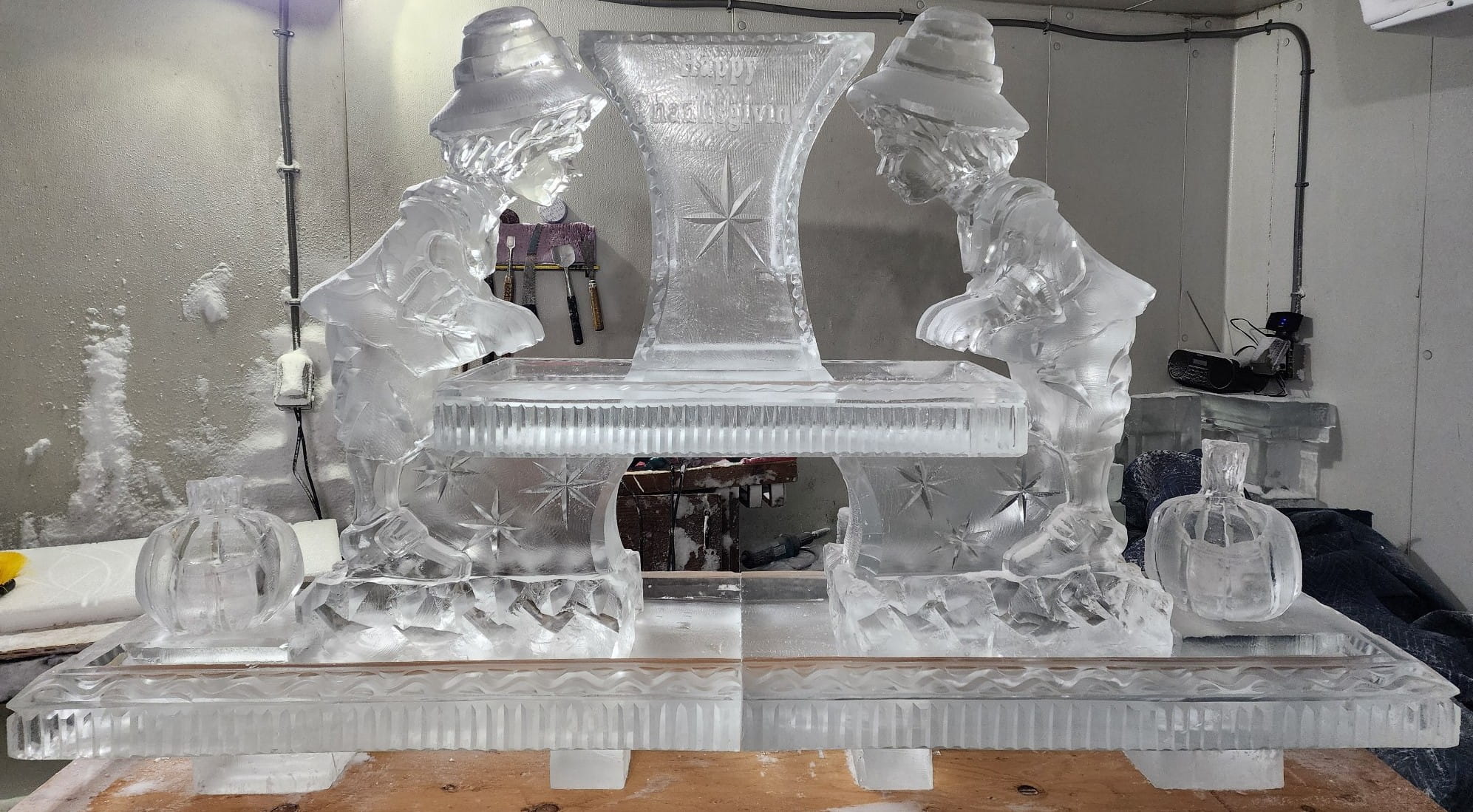 Ice matters 80 inch base tray with shrimp tower on raised center tray and carved pilgrim boy and pumpkin lemon holder on each side