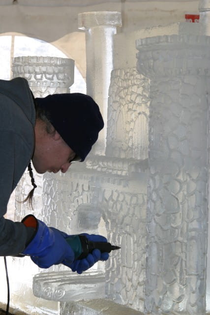 Meticulous close up of an artist refining a textured ice block surface