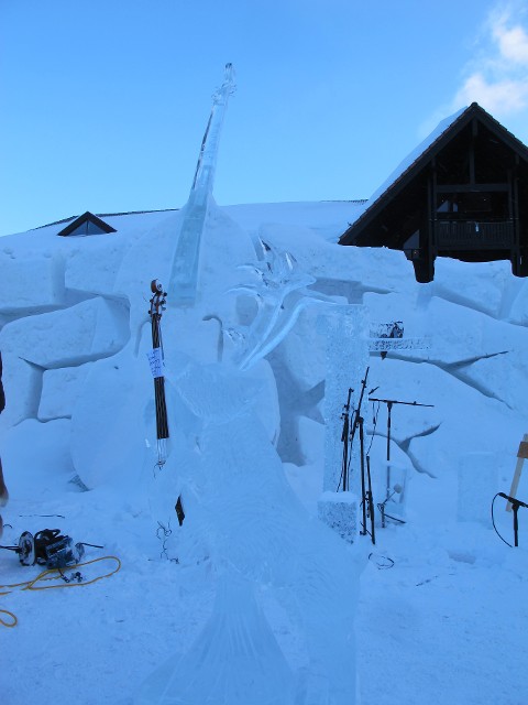 Large outdoor snow fort structure under construction at a winter festival grounds