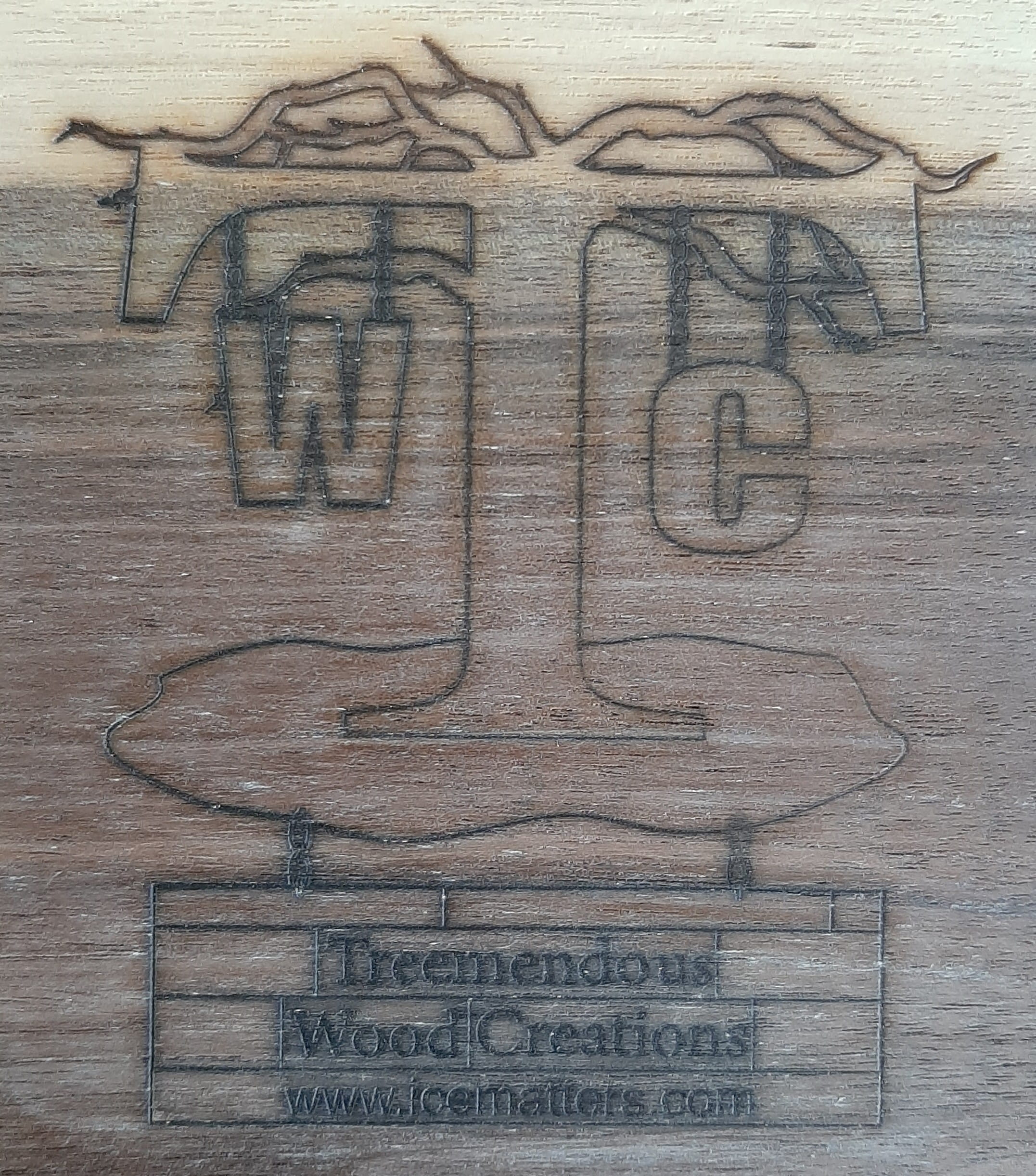 WC custom initial monogram engraved on a natural wood grain texture