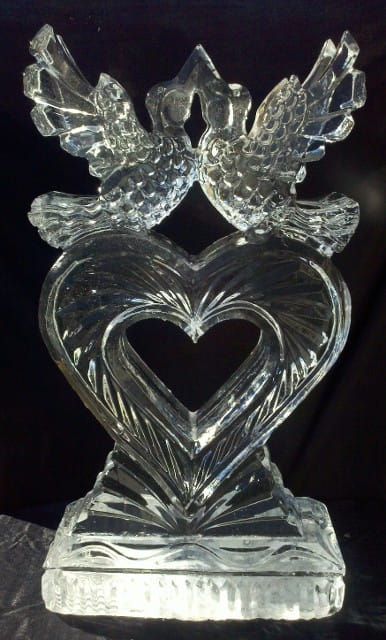 Interlocking double swans forming a heart shape clear ice sculpture
