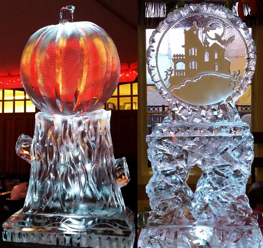 Glowing orange pumpkin Jack-o-lantern ice carving next to a winter display