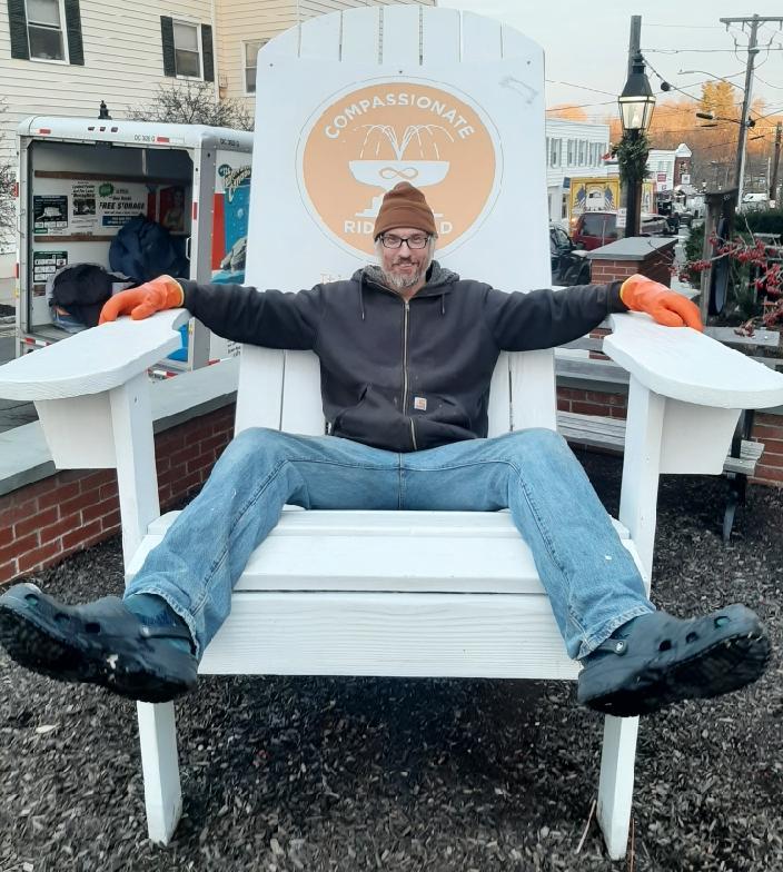 Man relaxing on a custom ice lounge chair built completely from ice blocks