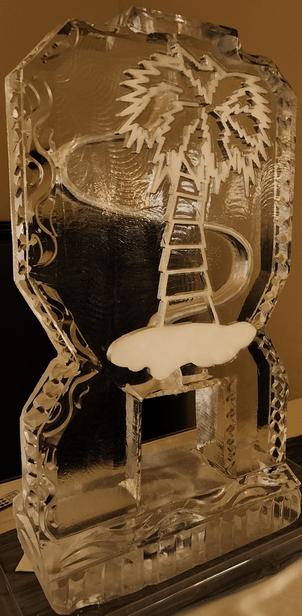 Beach-themed ice sculpture with palm tree and ladder