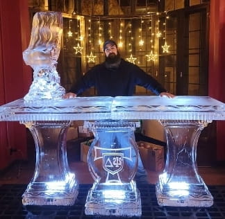 Fully lit custom ice bar counter display shining under bright warm lights