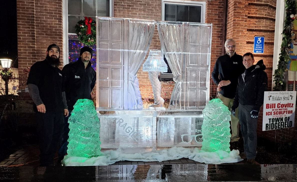 Elegant outdoor entryway display featuring block ice pillars and lighting
