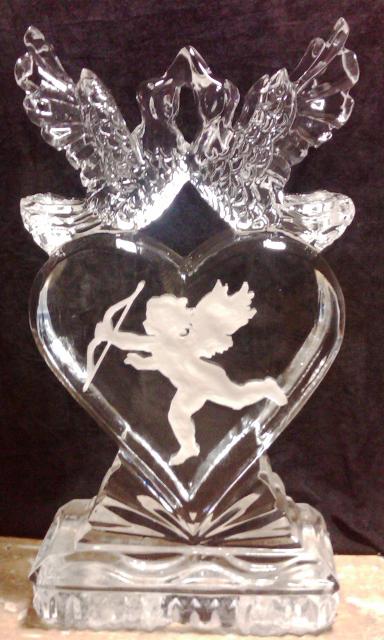 Heart-shaped ice sculpture with cupid engraving