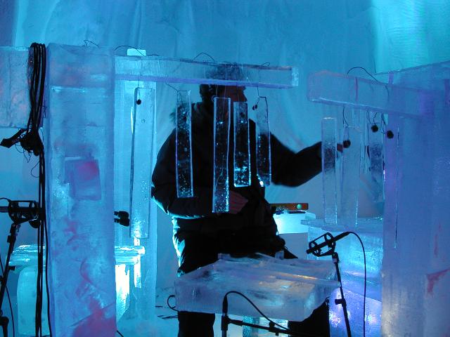 Ice bar installation illuminated with vibrant blue LED lights at a winter festival