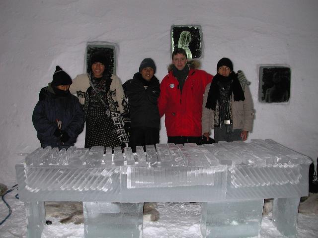 Group of event attendees posing next to a newly completed outdoor ice wall