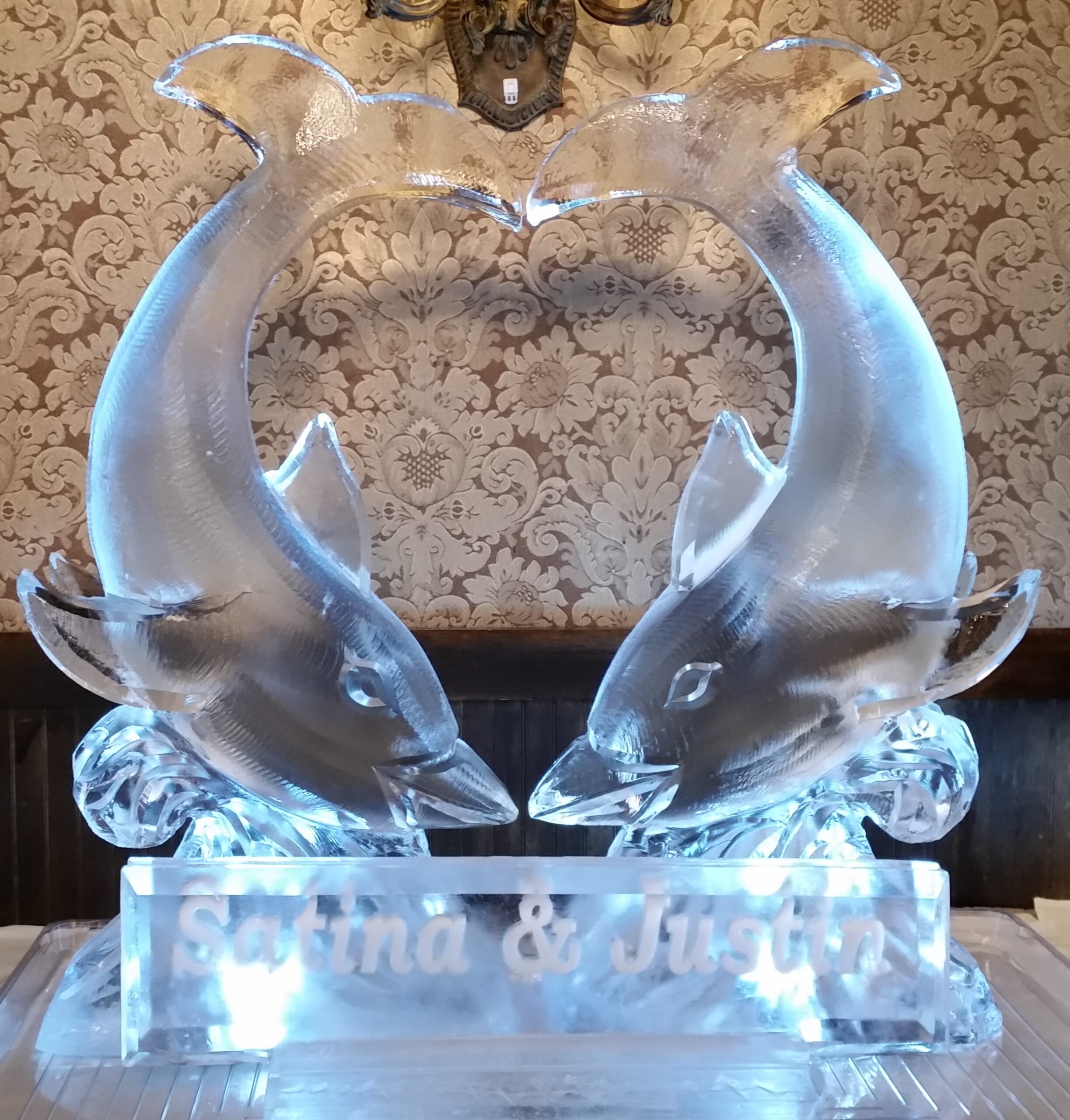 Swan ice sculpture with curved wings forming a heart
