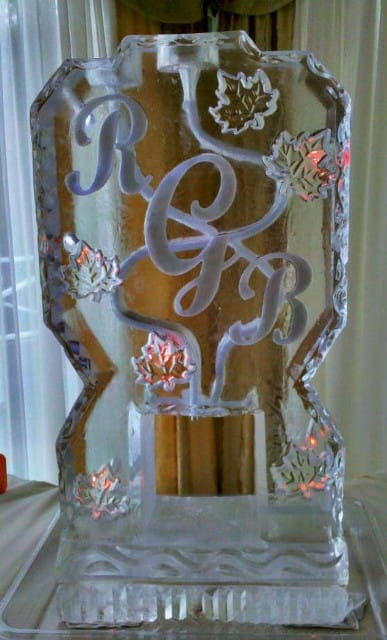 Decorative gold monogram ice sculpture with intertwined letters