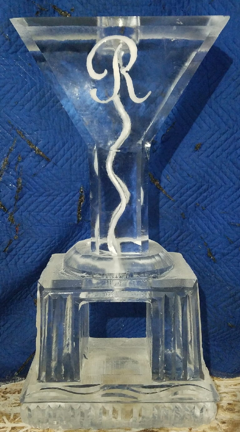 Elegant twisted ribbon ice sculpture with blue lighting