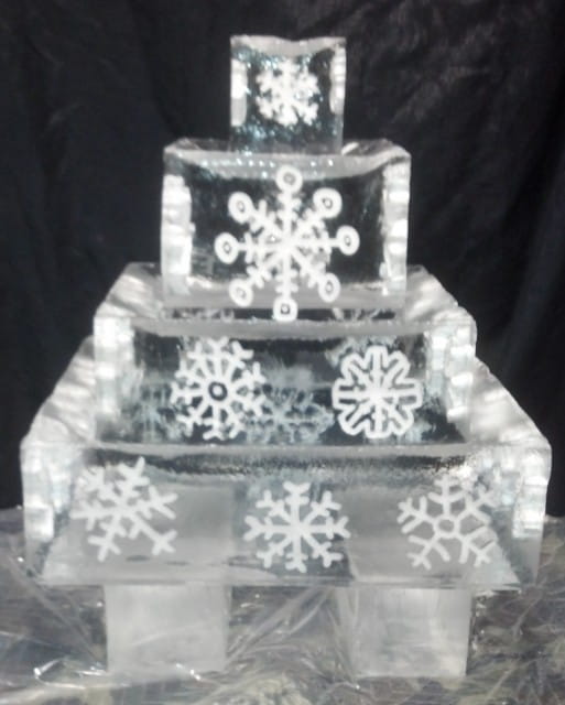 Snowflake-themed ice sculpture with stacked cube design for winter event décor