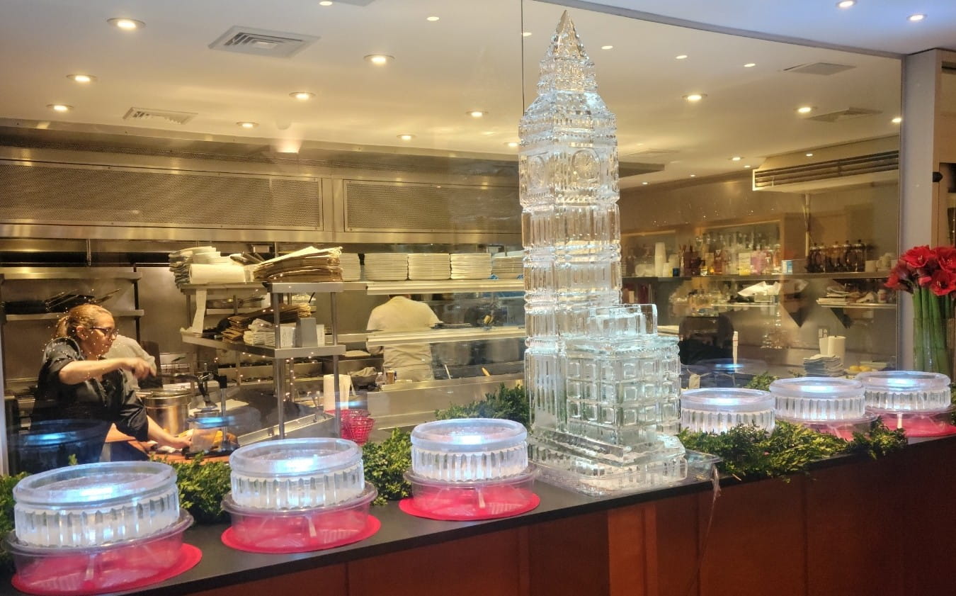 Illuminated tower ice sculpture centerpiece