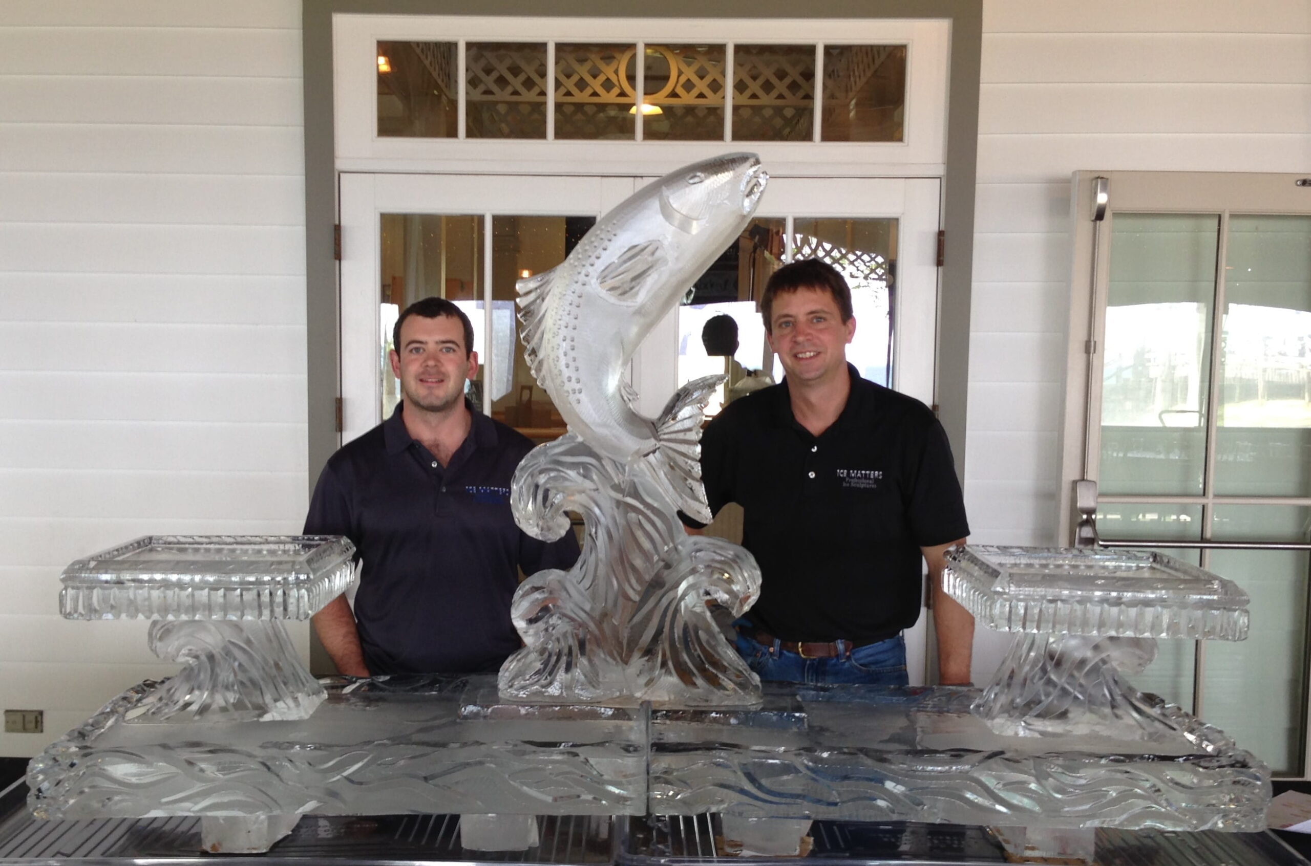 Custom marlin ice sculpture with clients