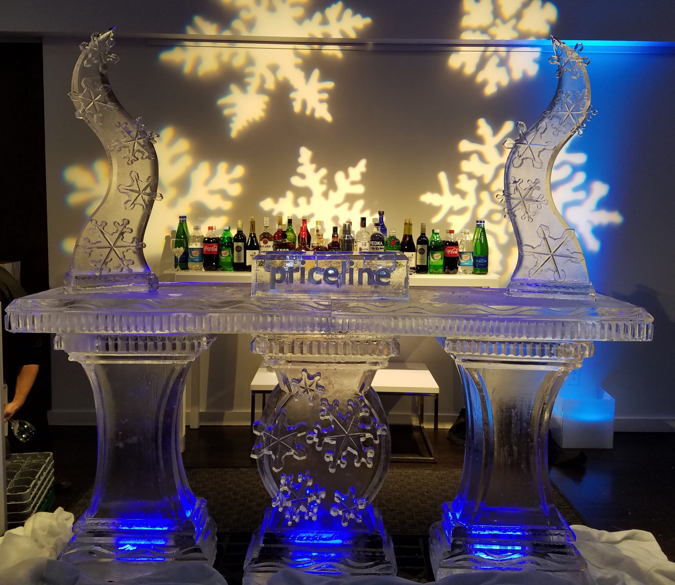 Winter-themed illuminated ice bar with snowflake carvings
