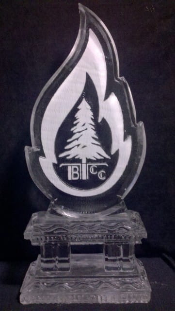 Flame shape ice sculpture featuring an embedded pine tree engraving