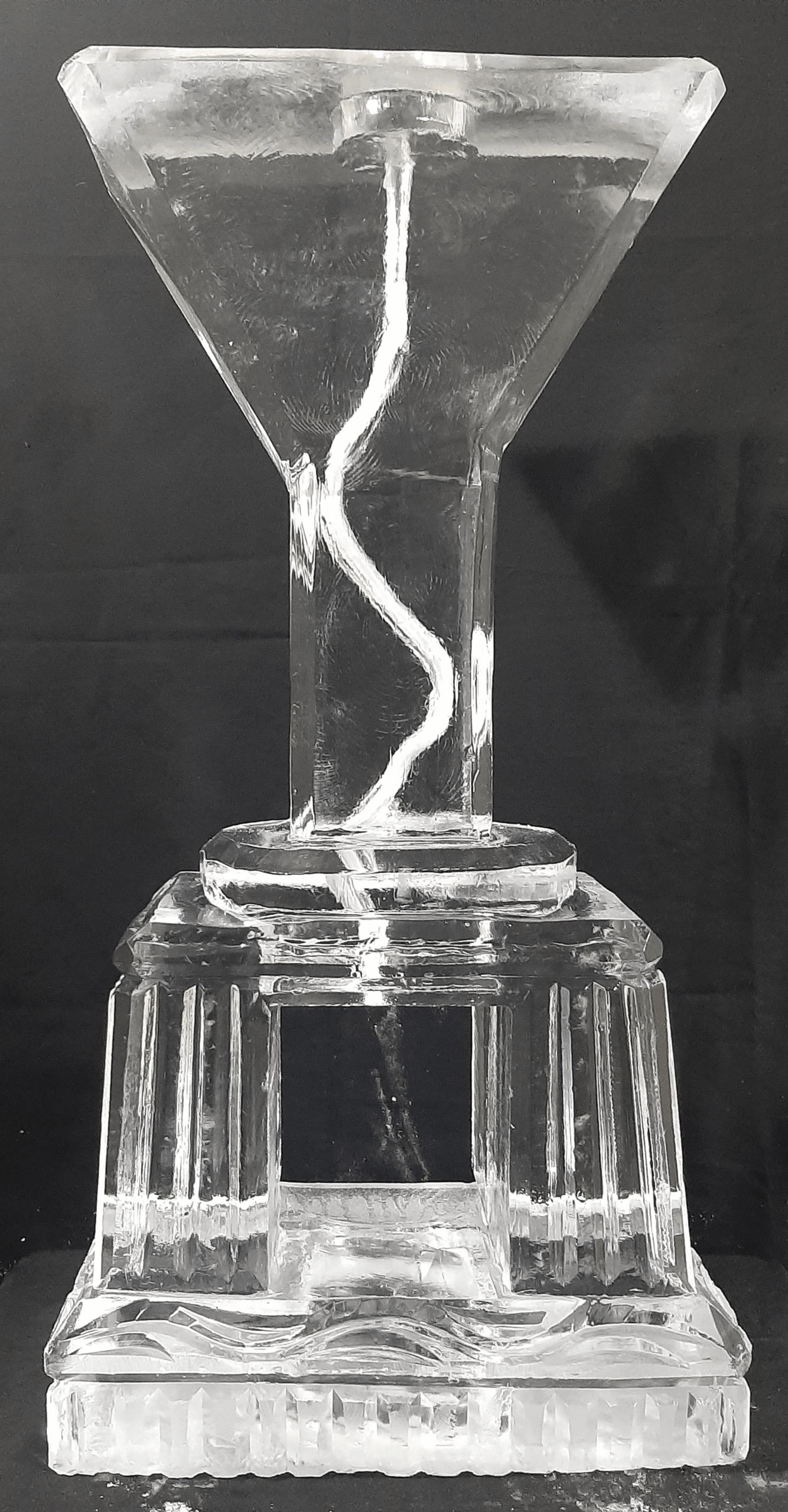 Twisting spiral ice sculpture on pedestal