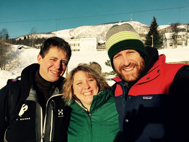 Happy smiling family group portrait together outdoors in winter weather gear