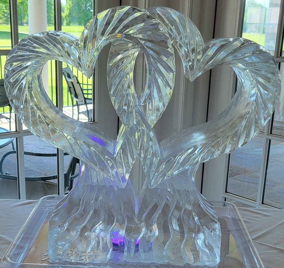 Elegant interlocking double swans ice sculpture for a wedding reception
