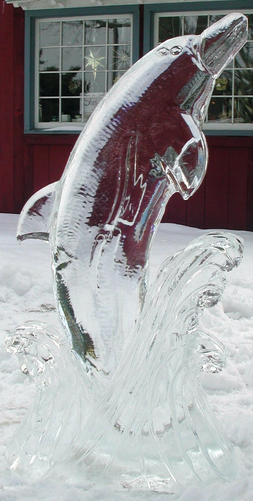 Abstract fluid wave custom ice sculpture casting reflections outdoors