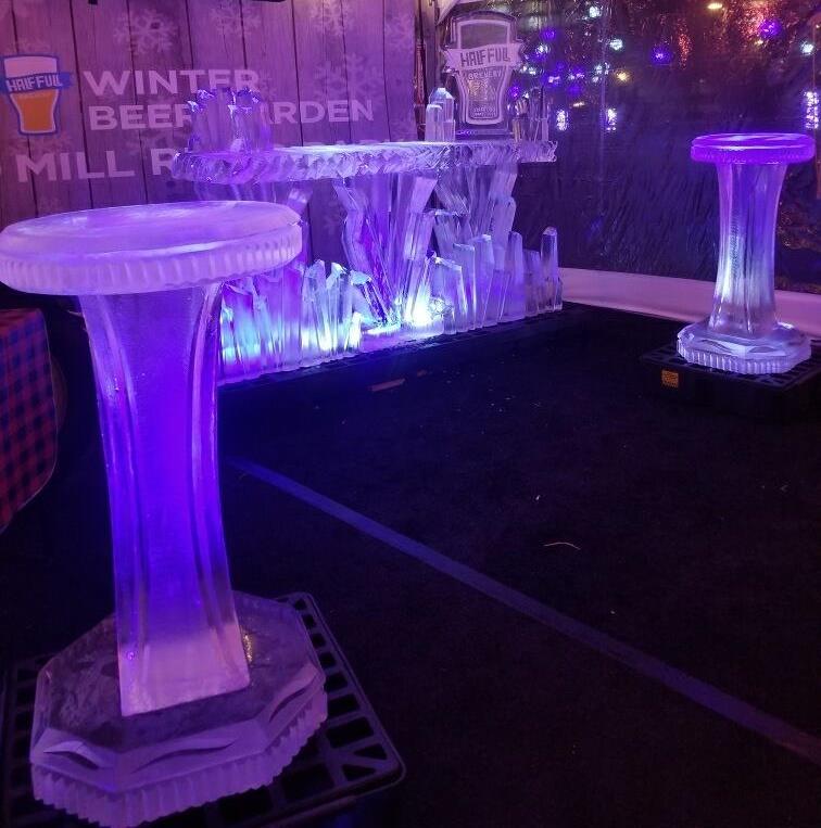 Elegant illuminated ice bar with drink display