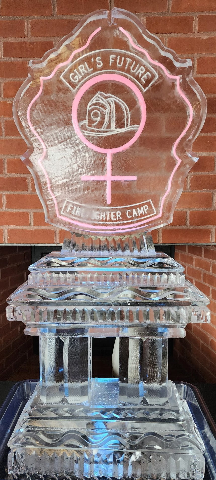 Custom female gender symbol pink ice sculpture for a themed event