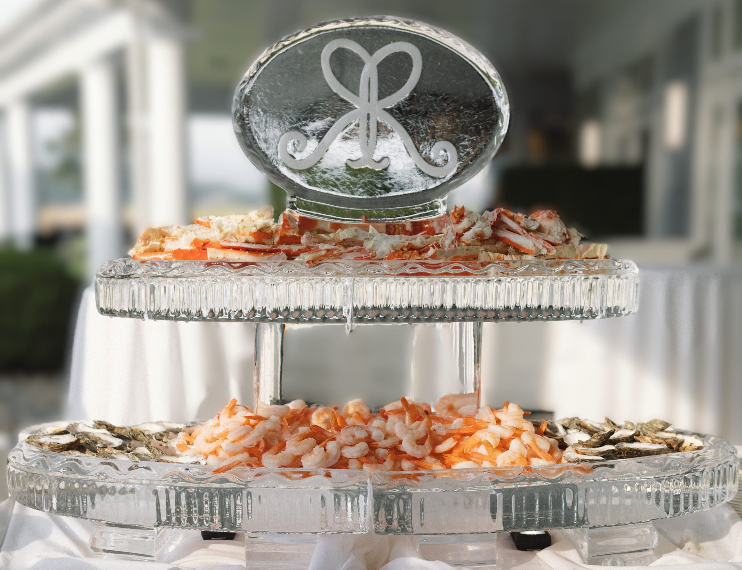 Oval monogram ice sculpture with seafood display
