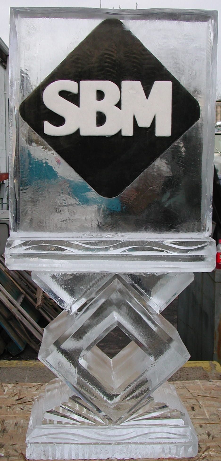 SBM corporate logo block ice sculpture on a display stand