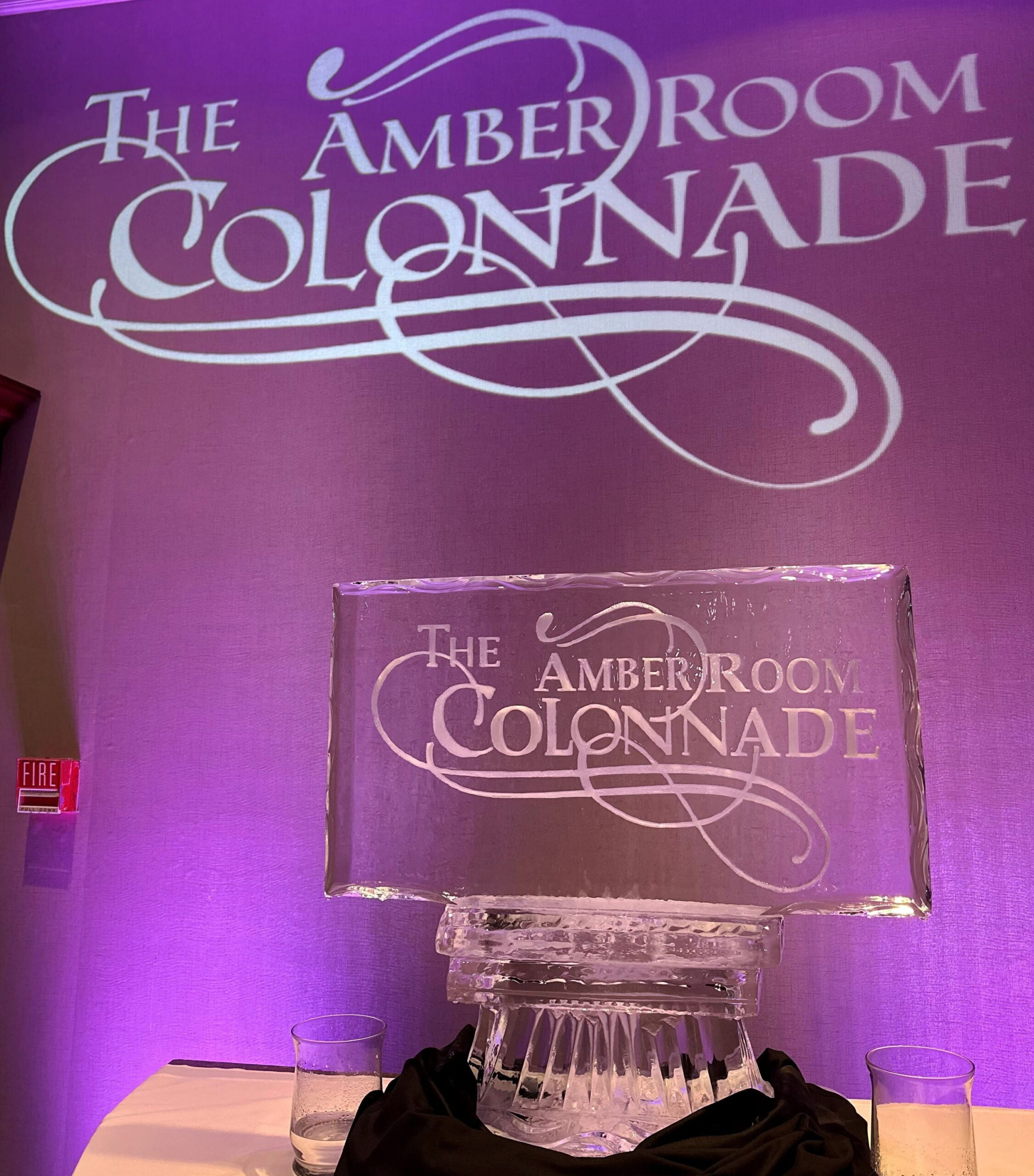 The Amber Room Colonnade elegant event venue logo ice sculpture lit in purple