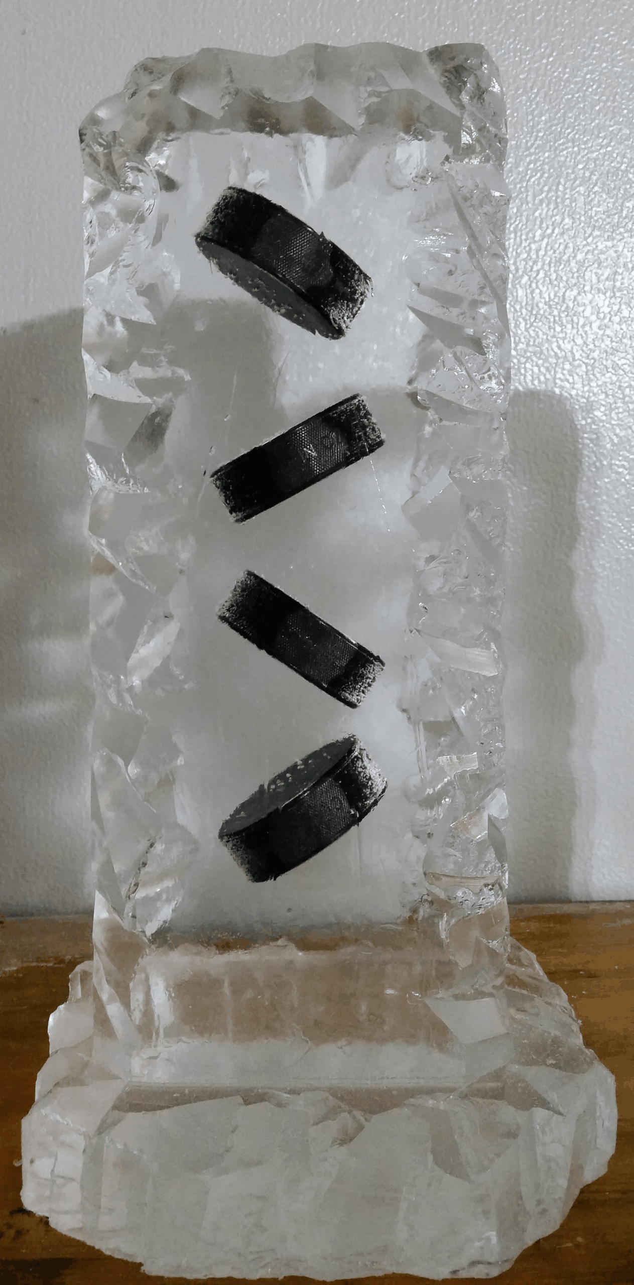 Ice sculpture with embedded black decorative accents