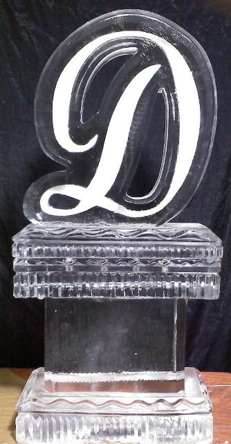 Elegant script letter D ice sculpture on a display stand