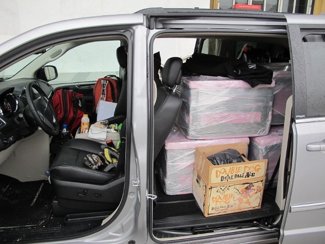 Delivery vehicle transport cargo area packed with equipment boxes for event setup