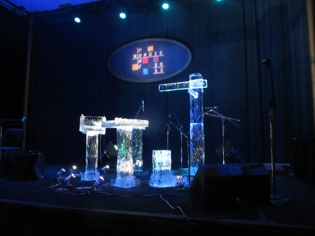 Corporate event main stage with branded graphic backdrop and lighting setup