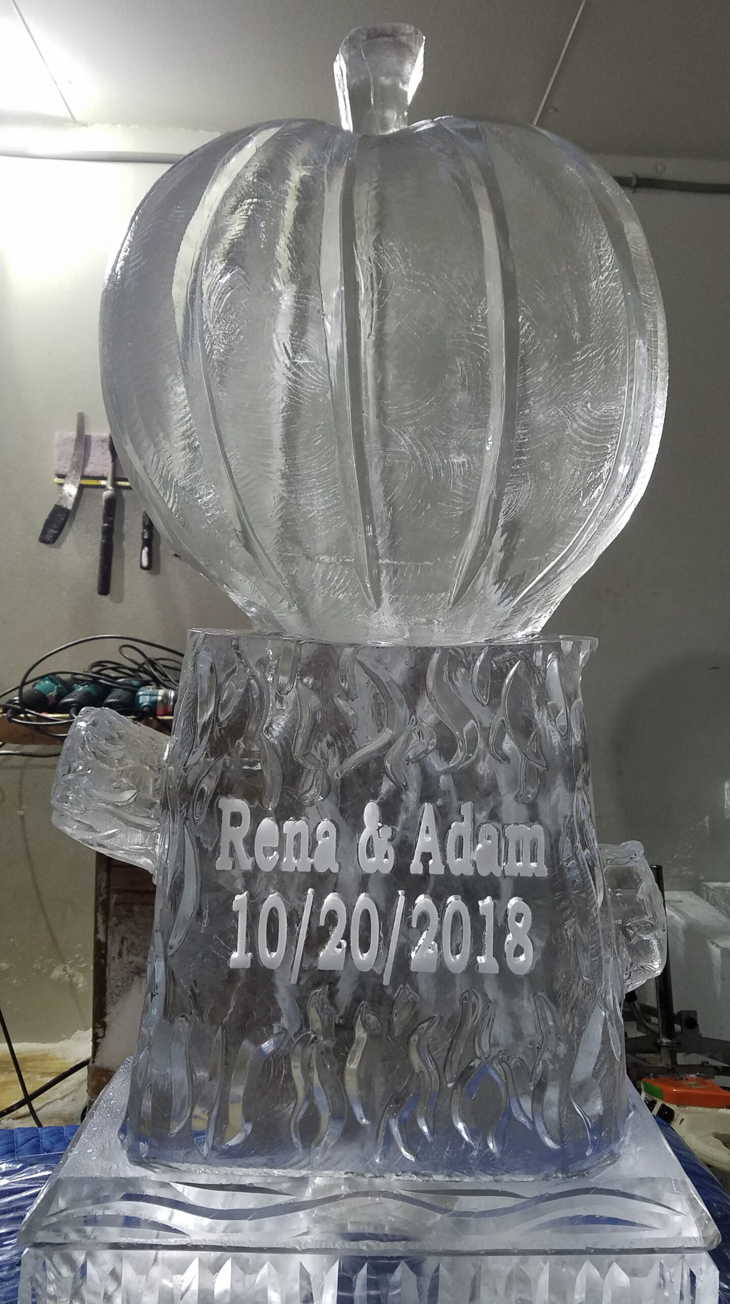 Intricate custom ice carving of a vase or urn display