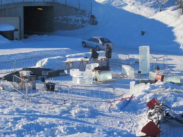 Wide outdoor shot of heavy equipment preparing large ice cubes in the snow
