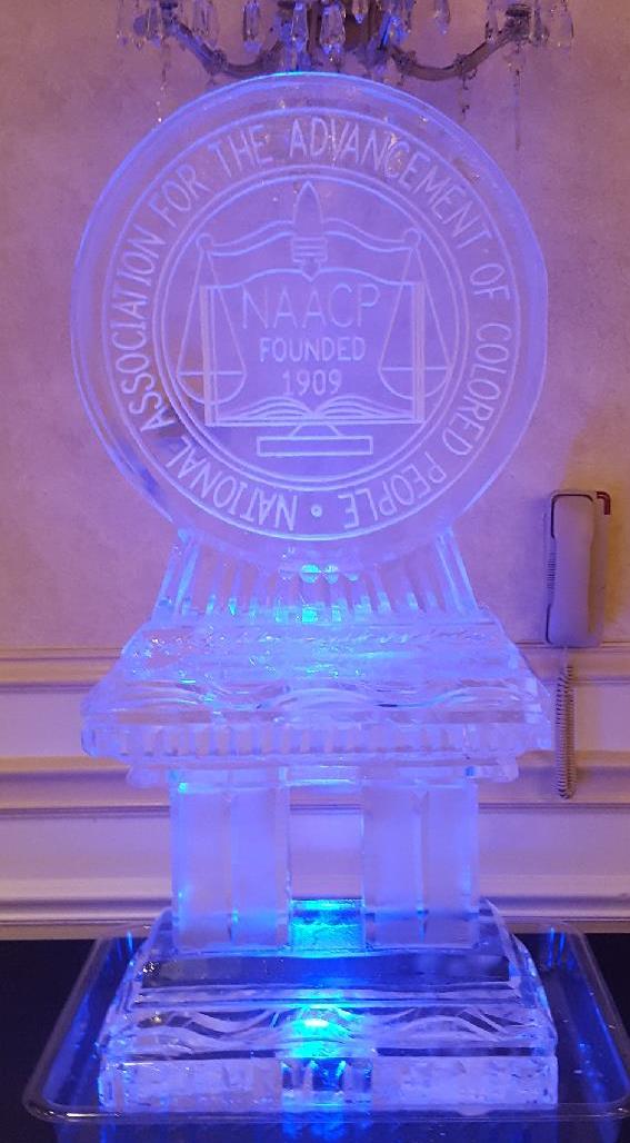 Custom circular corporate emblem ice sculpture lit up with blue LED lighting