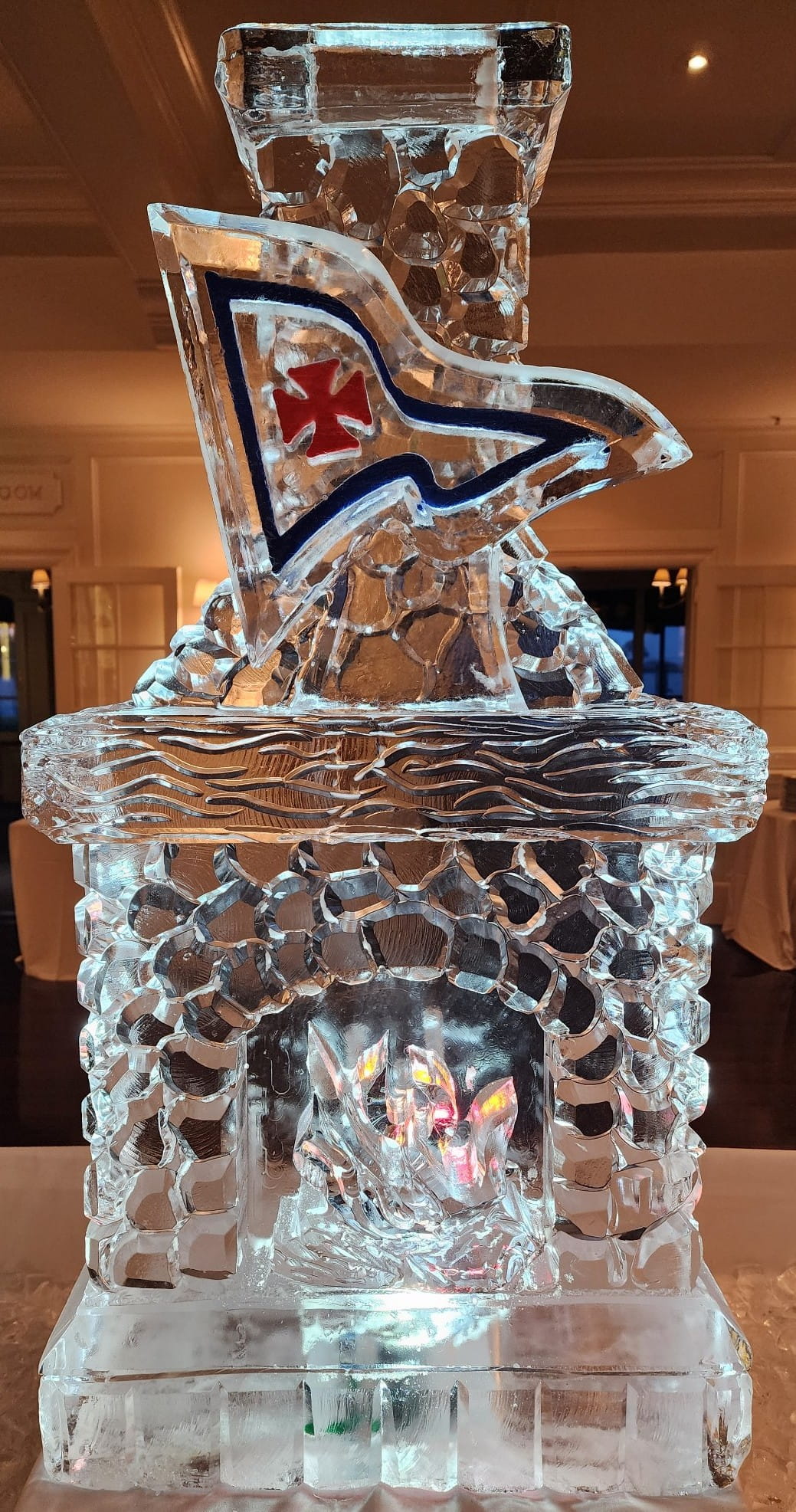Ice matters - stone fireplace with colored burgee on wood mantle