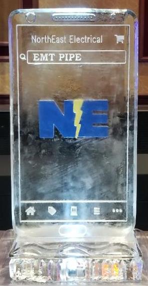 NE corporate logo block ice sculpture with blue and yellow accents