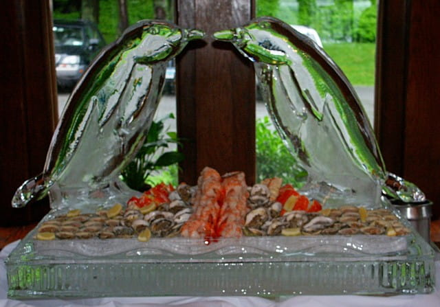 Arched ice buffet display with floral centerpiece