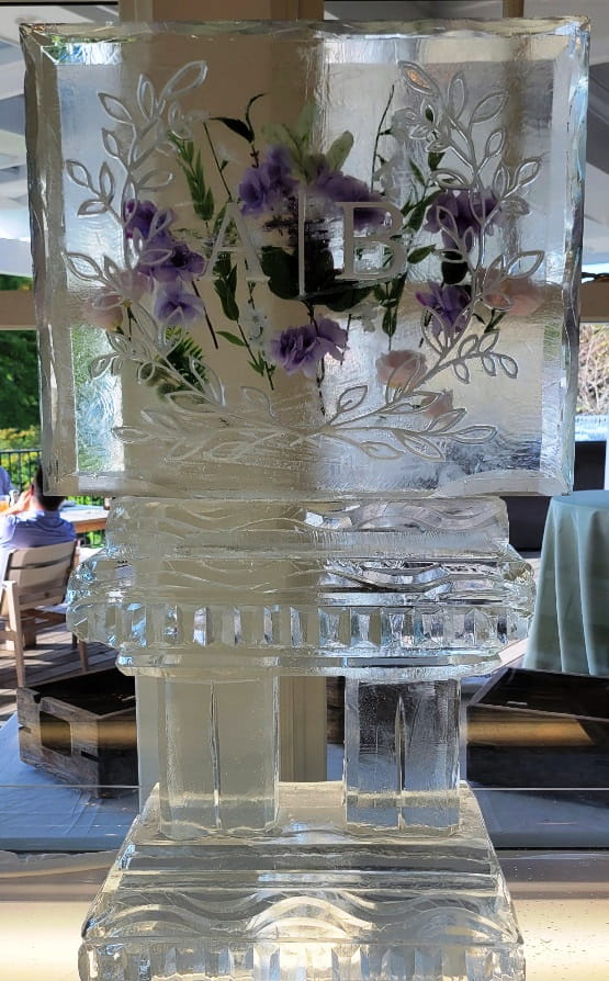 Floral-themed engraved ice sculpture centerpiece