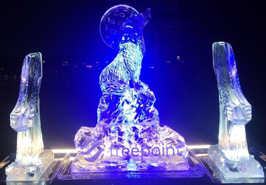 Stunning abstract sculptural ice carving illuminated with brilliant blue light