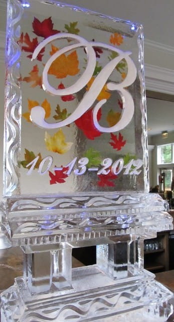 Personalized wedding ice sculpture with floral accents and date