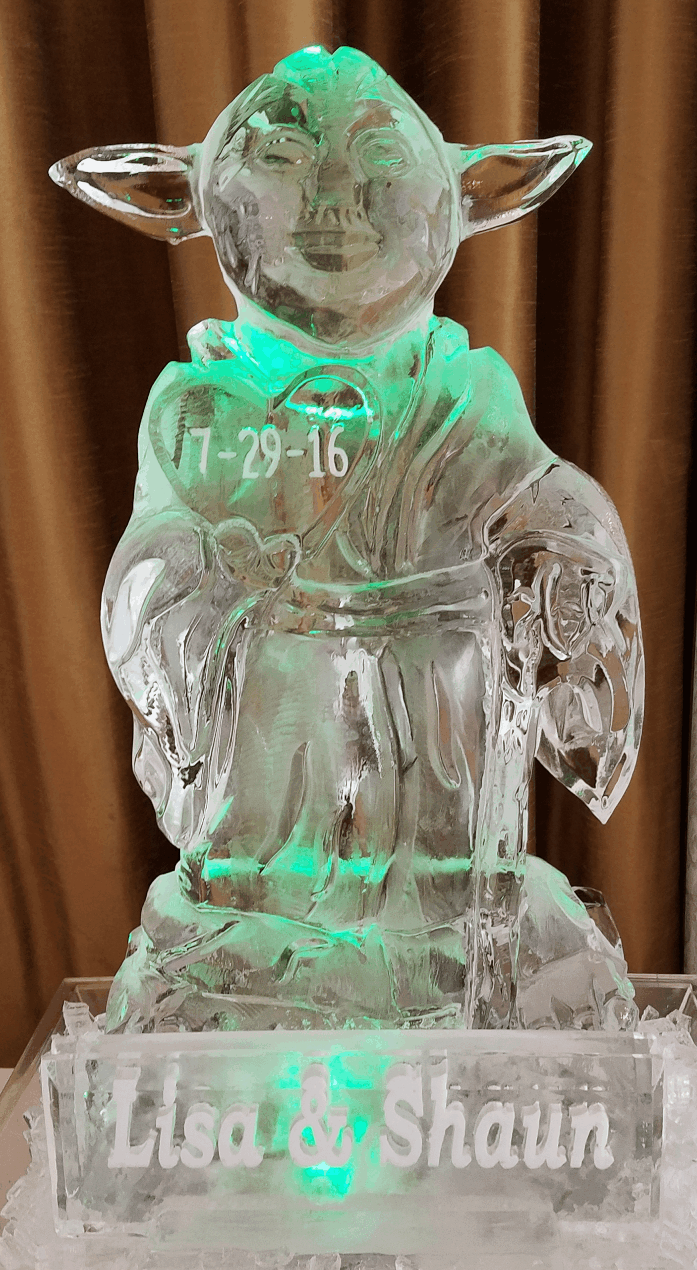 Angel ice sculpture with detailed wings and flowing robe