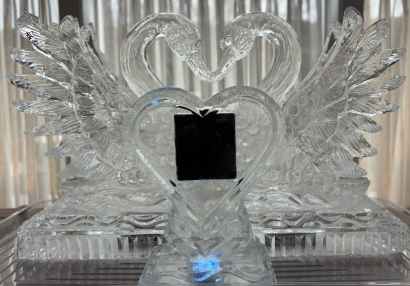 Double swan ice sculpture with a black square center display placeholder