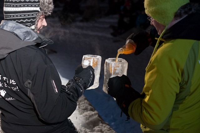 People interacting at a winter event ice bar serving drinks