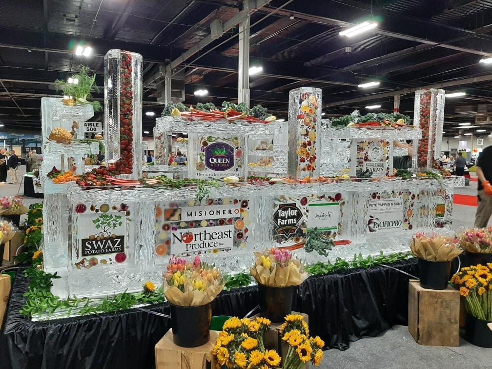 Elaborate corporate event ice bar and buffet display setup indoors